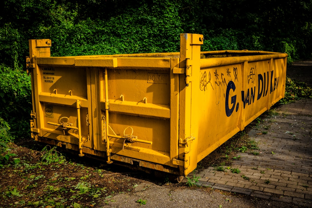 Gele afvalcontainer op een bouwlocatie